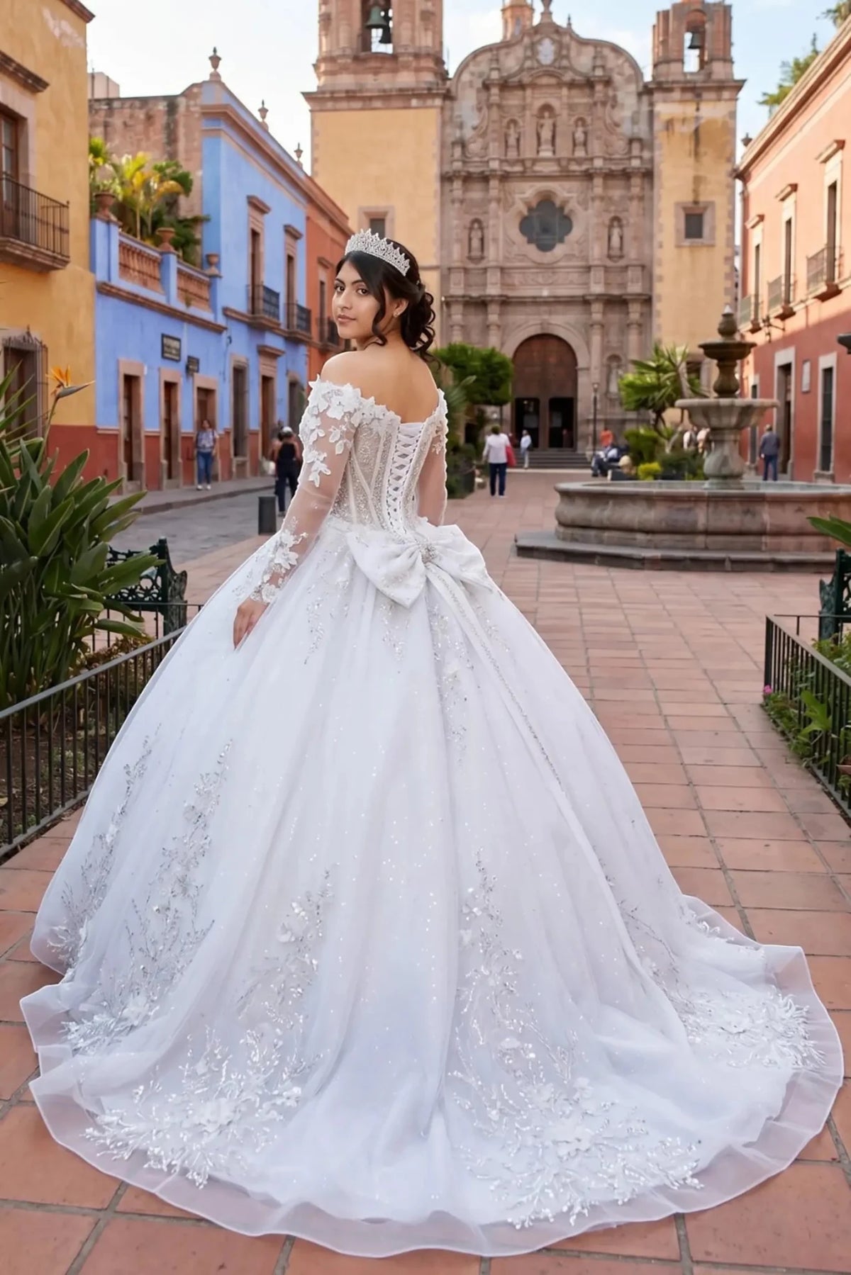 Rear view reveals off-white ball gown dress with lace up back, back bow and beadwork long train.