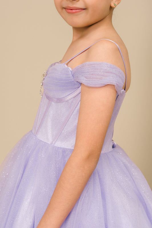 girl showing her side and wearing a lilac Off-Shoulder Tulle Dress on a beige background