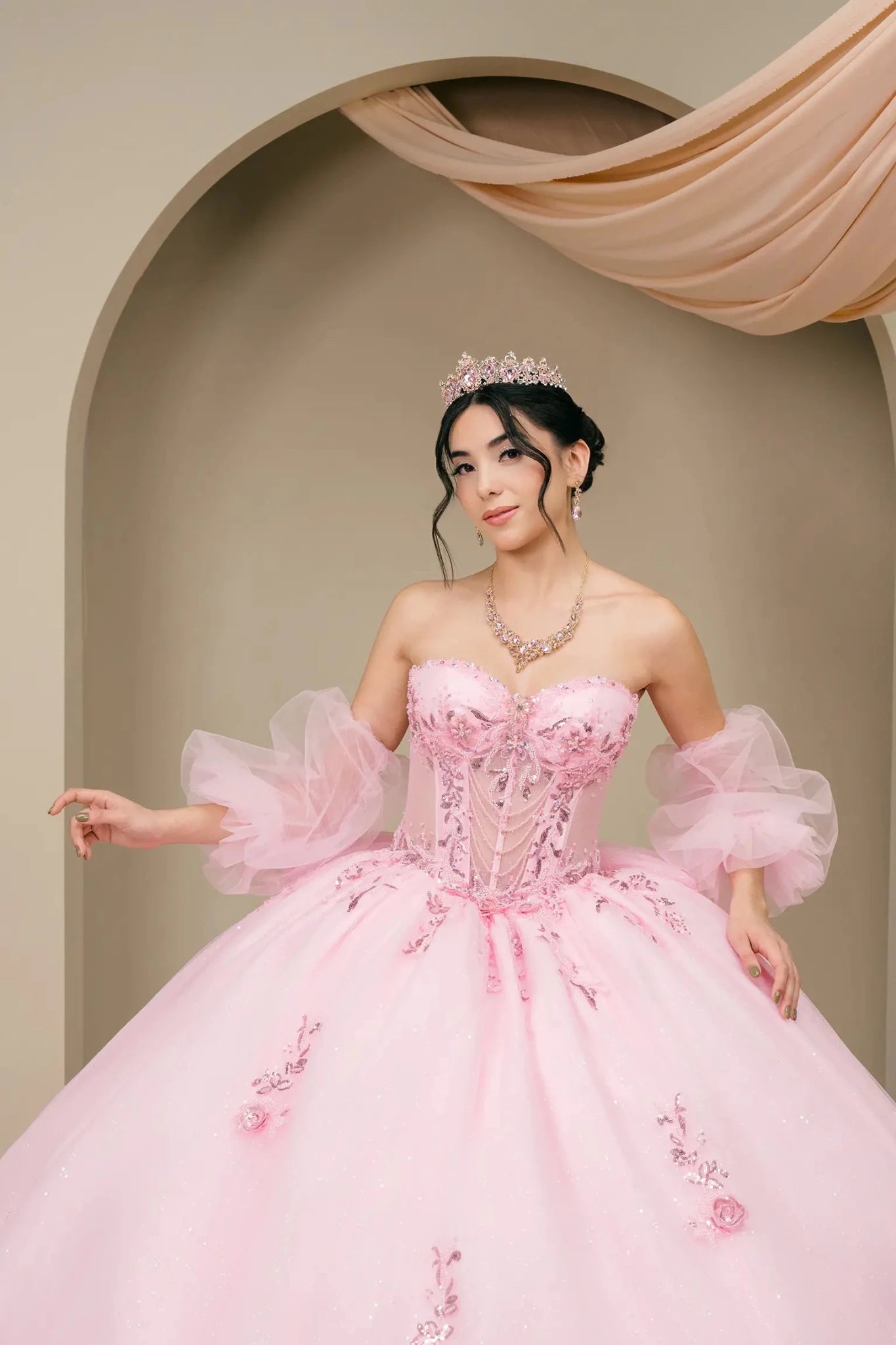 Front medium view of the pink quinceañera ball gown highlighting the embellished corset bodice and puff sleeves