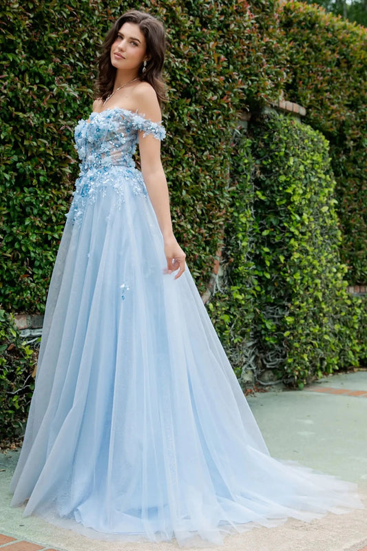 A full-length view of a woman wearing blue fairytale prom dress with a lace-up corset and layered tulle skirt.
