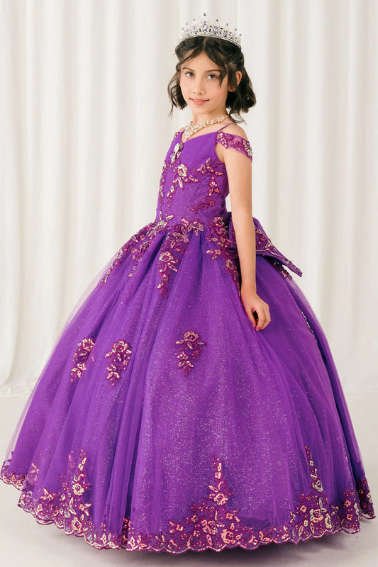 Side full-length view of Magenta Rose mini quince off shoulder ball gown with embroidered bodice, gemstone accent, glitter tulle skirt, lace up back, and oversized bow