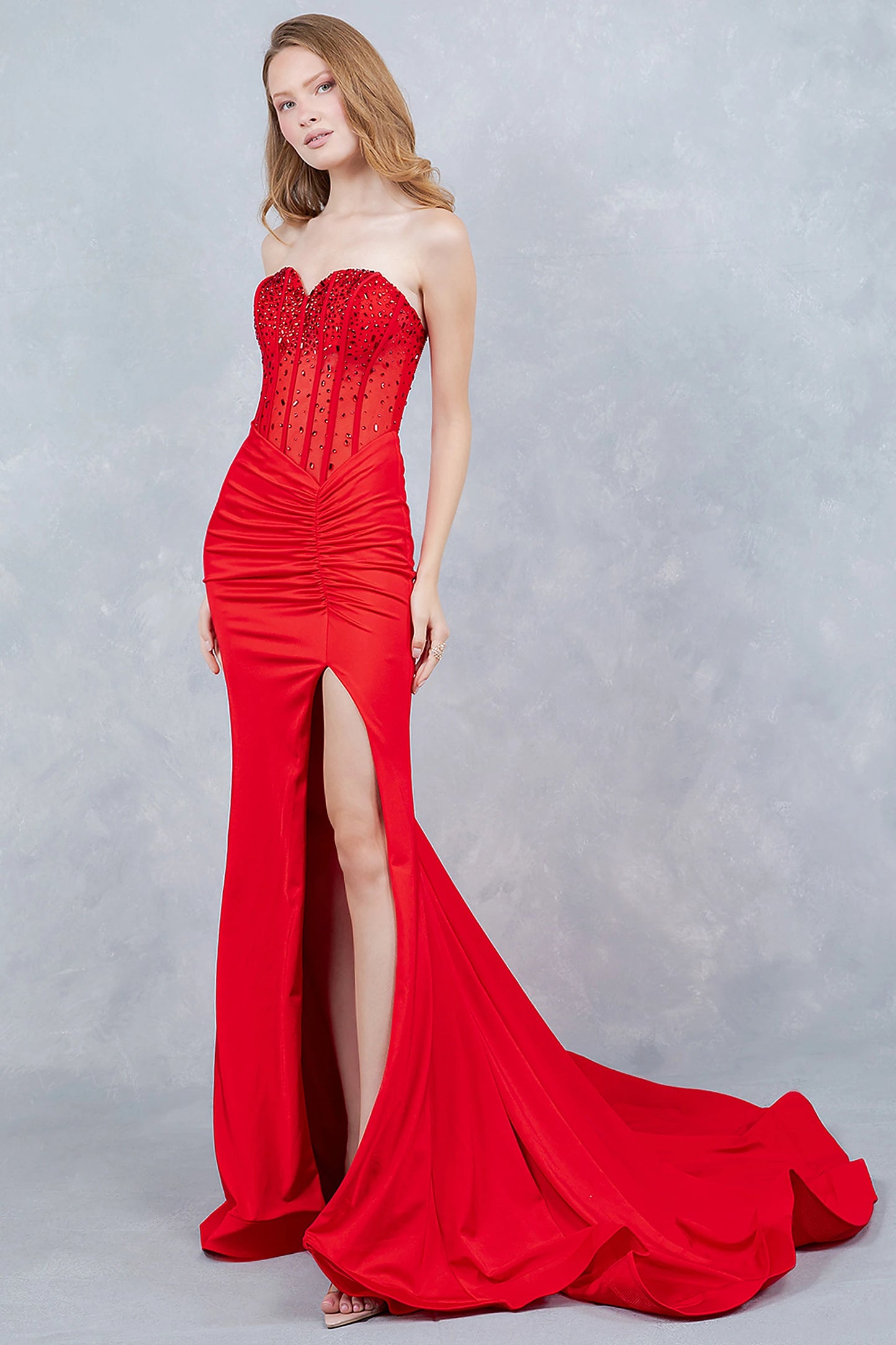 Red prom dress showcasing fitted skirt with thigh-high slit