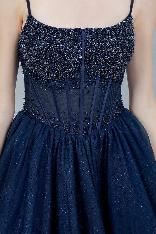 Navy evening dress featuring clustered embellishments cascading for sculpted effect
