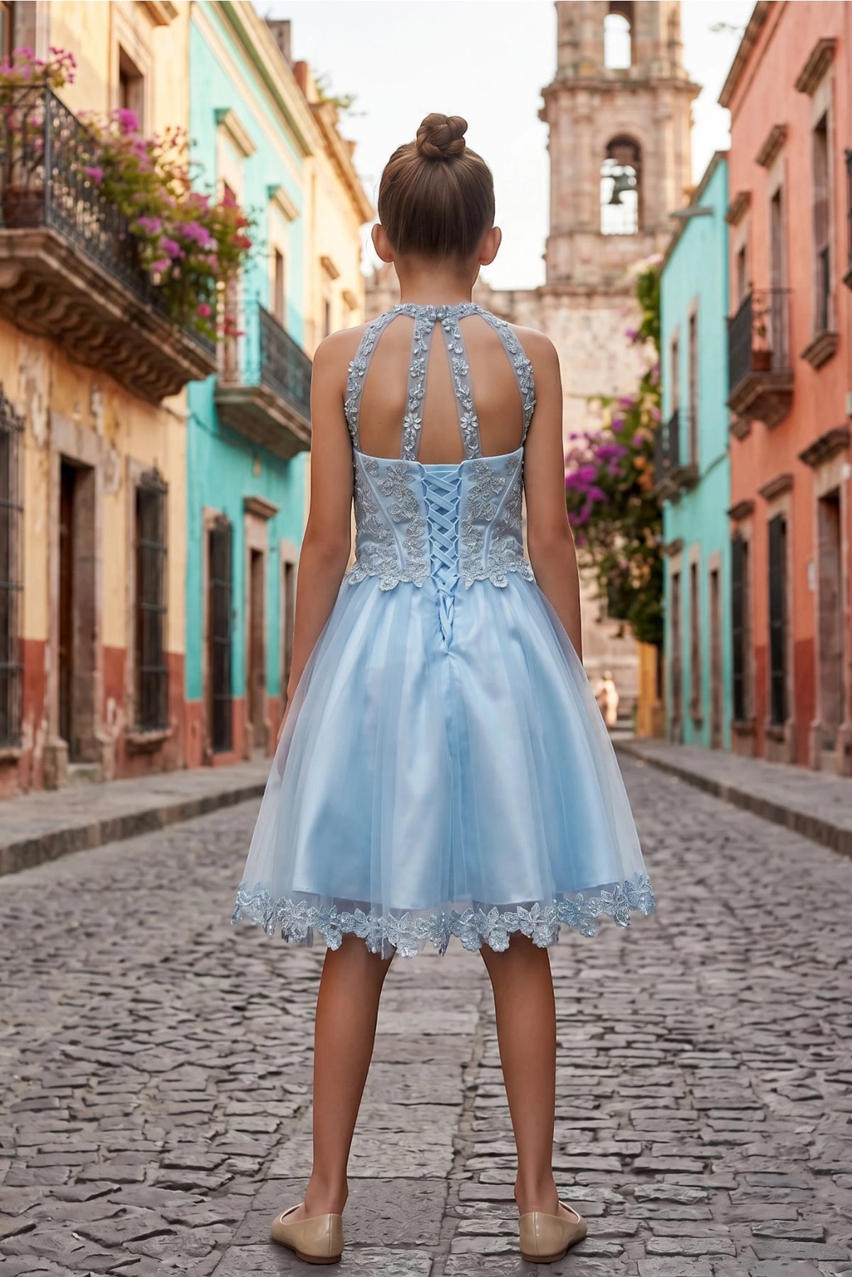 Finished details of crisscross lacing and a halter opening distinguish the Blue kids party dress.