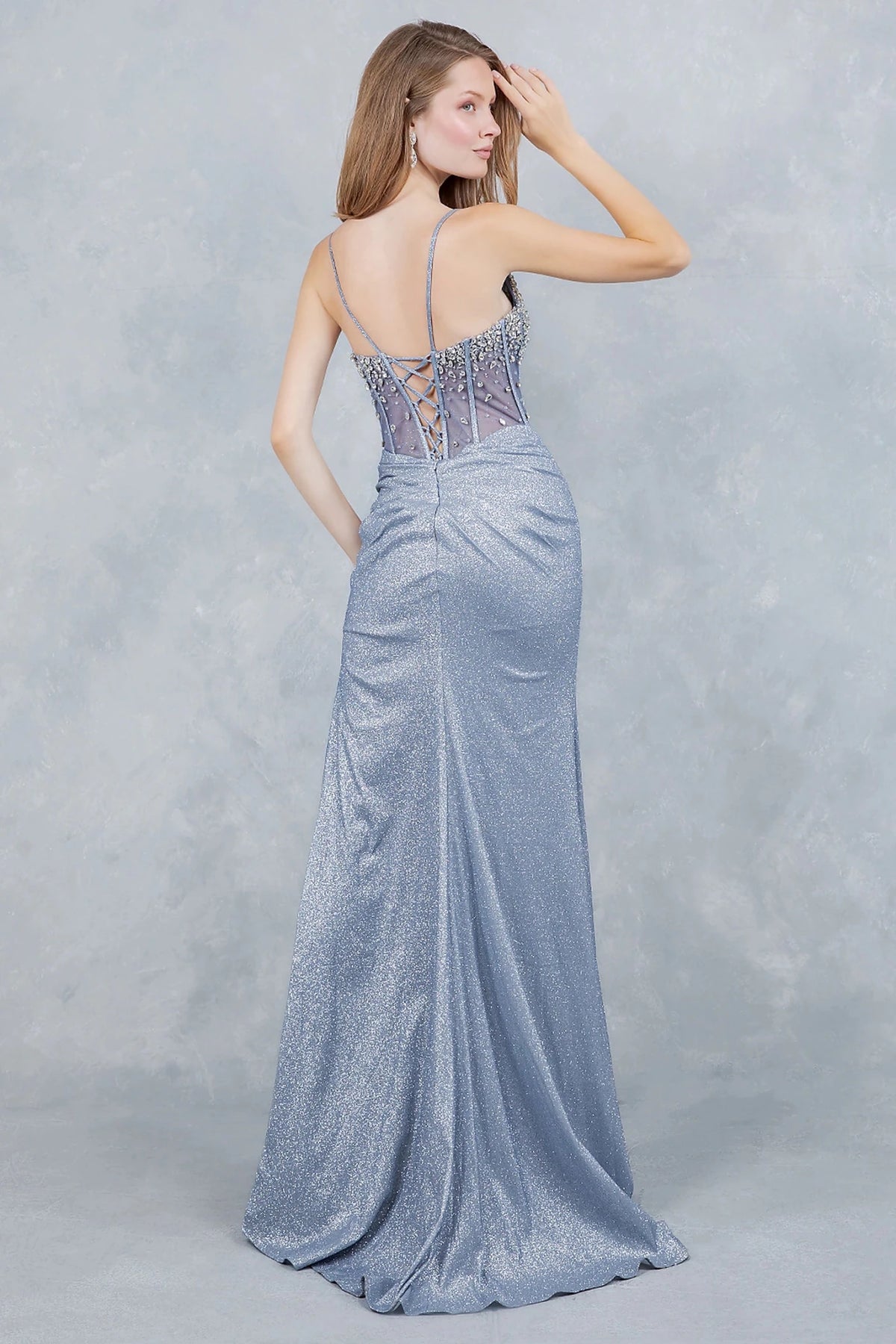 Rear view reveals dusty Blue evening gown showcasing lace-up back with delicate spaghetti straps.