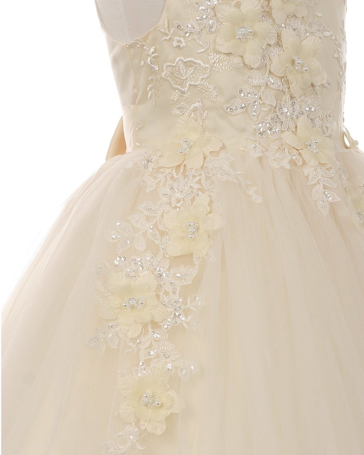 Close-up of a champagne floral flower girl dress with intricate details.