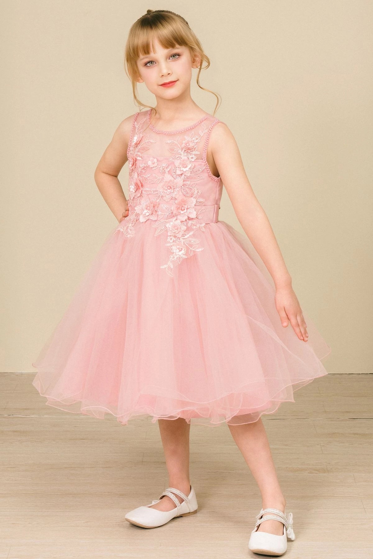 Featuring beaded neckline above the floral bodice on the Dusty Rose flower girl dress.