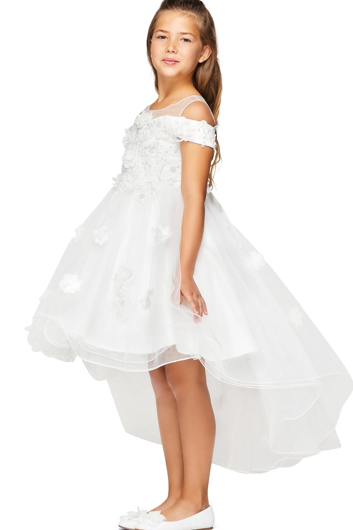 Detailed by dimensional flowers across the bodice, the White kids party dress reveals its construction.