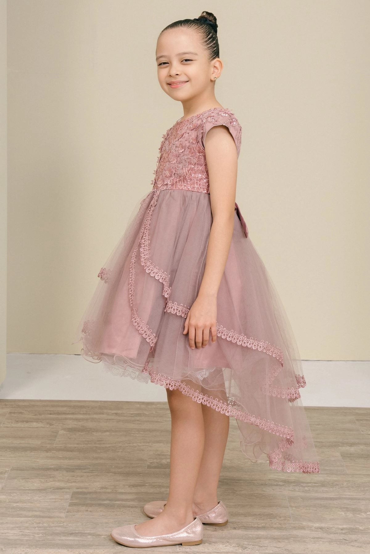 Featuring lace-trimmed tiers and longer back hem on the Mauve flower girl dress.