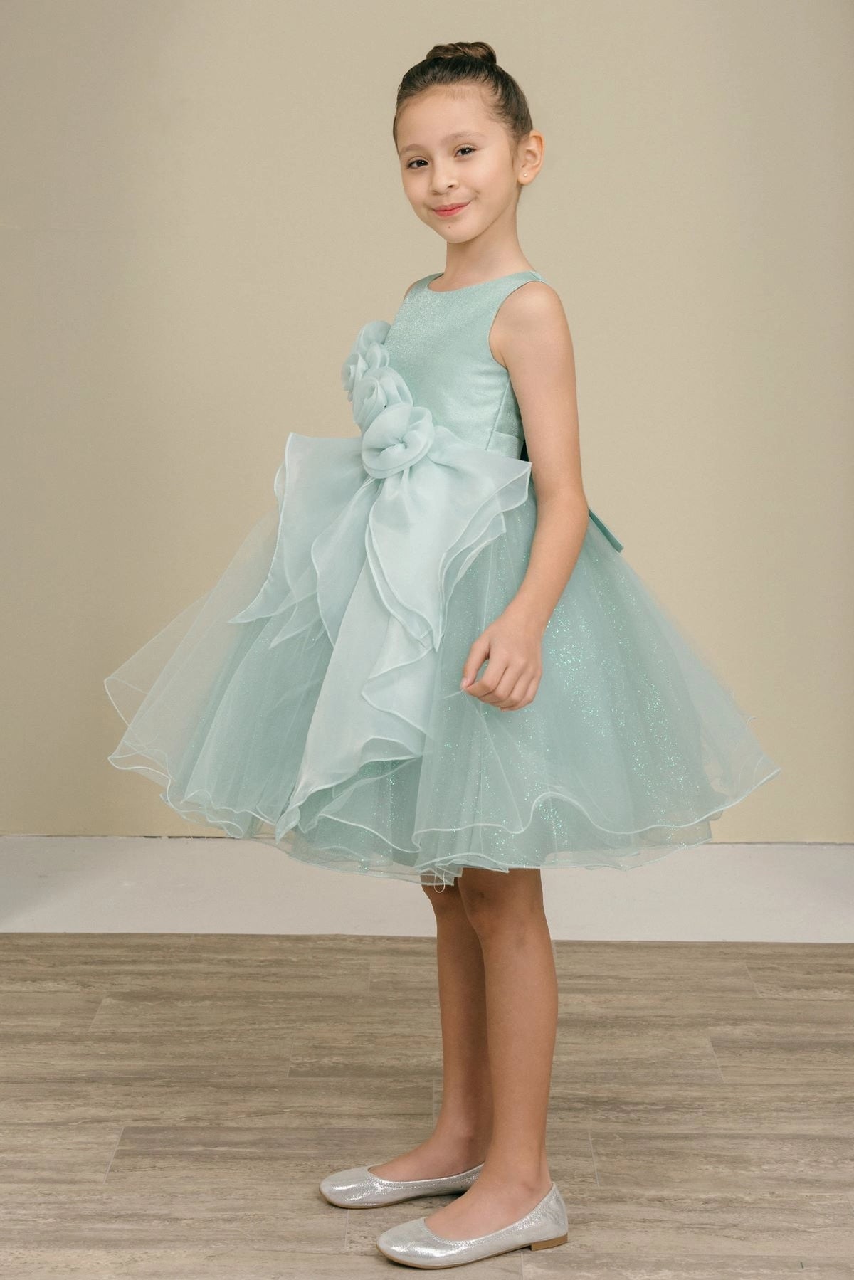 Featuring soft ruffles beside the layered hem on the Sage flower girl dress.