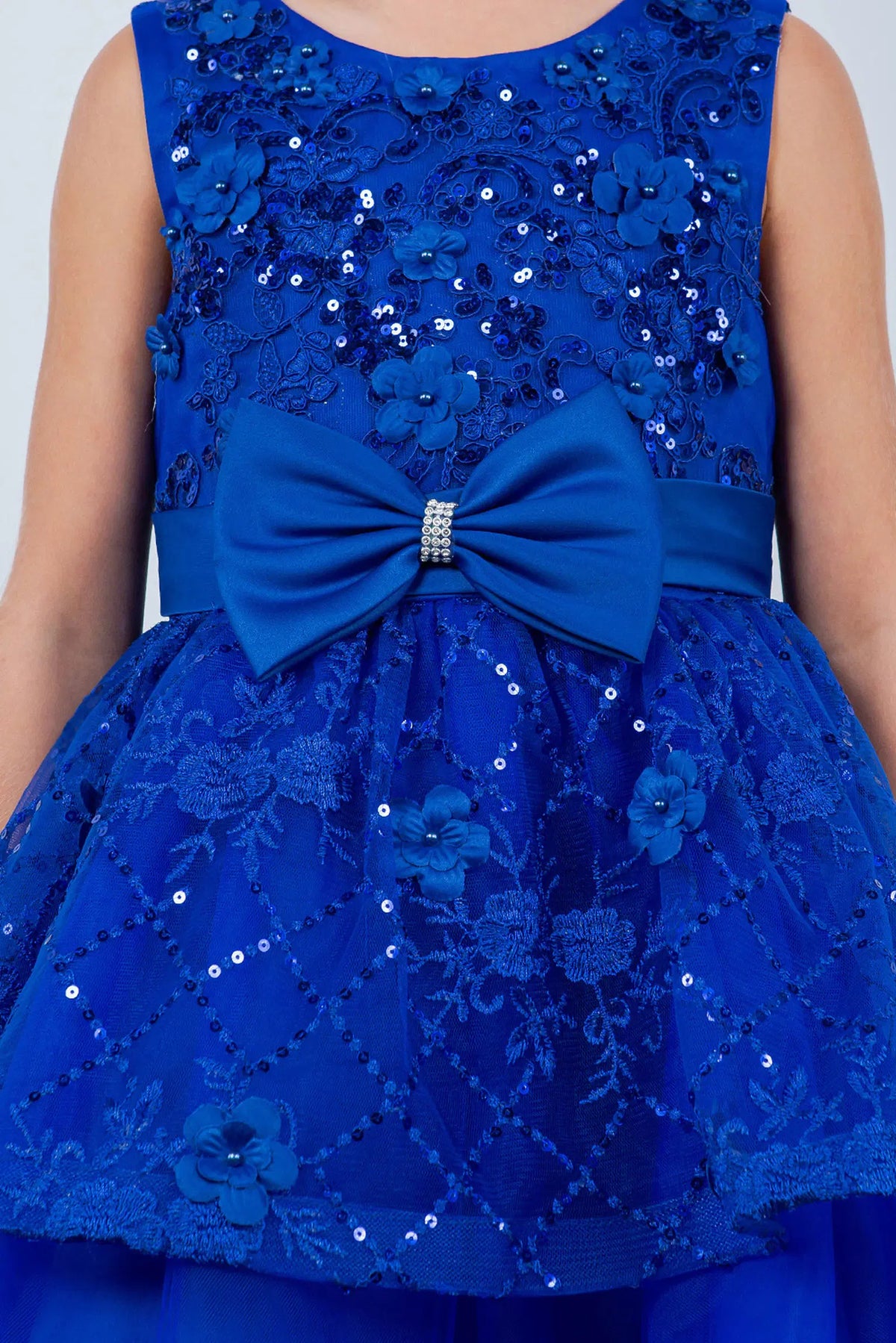 Showcasing with floral accents across the bodice, this Royal Blue kids party dress displays elegant detail.