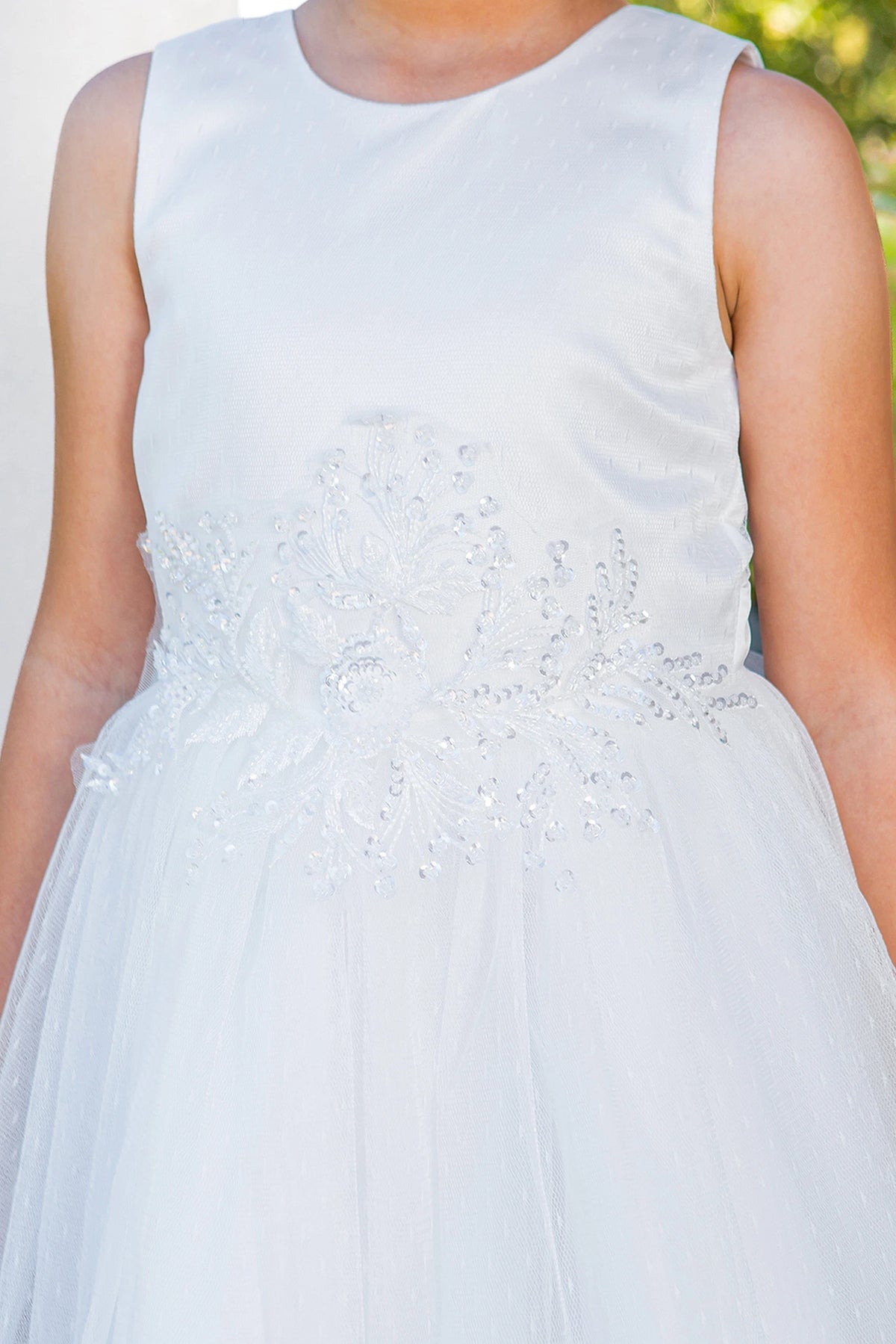 Visible on this White flower girl dress: floral waistband beneath a satin bodice.