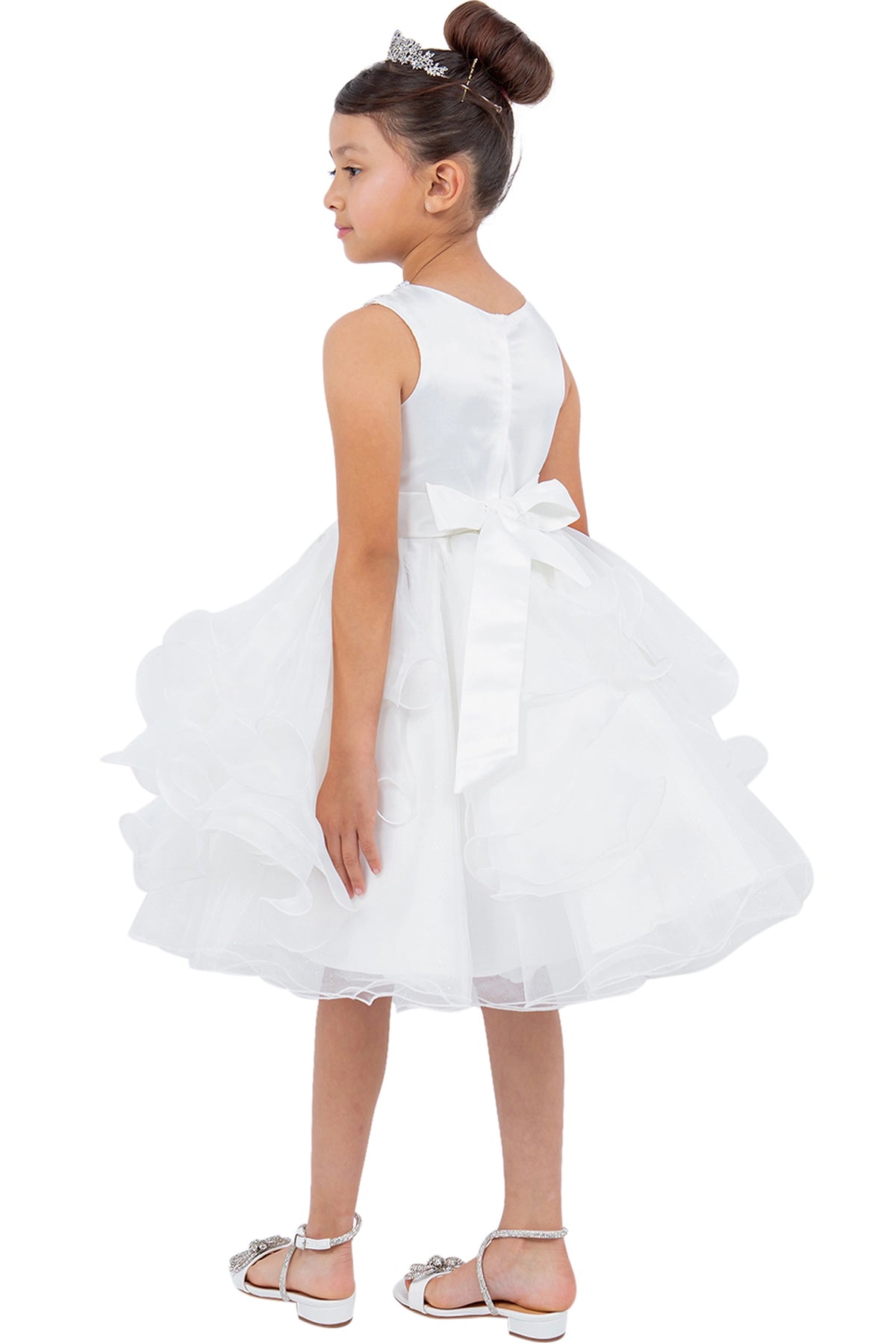 A Off-White flower girl dress showing back sash bow above the ruffled skirt.