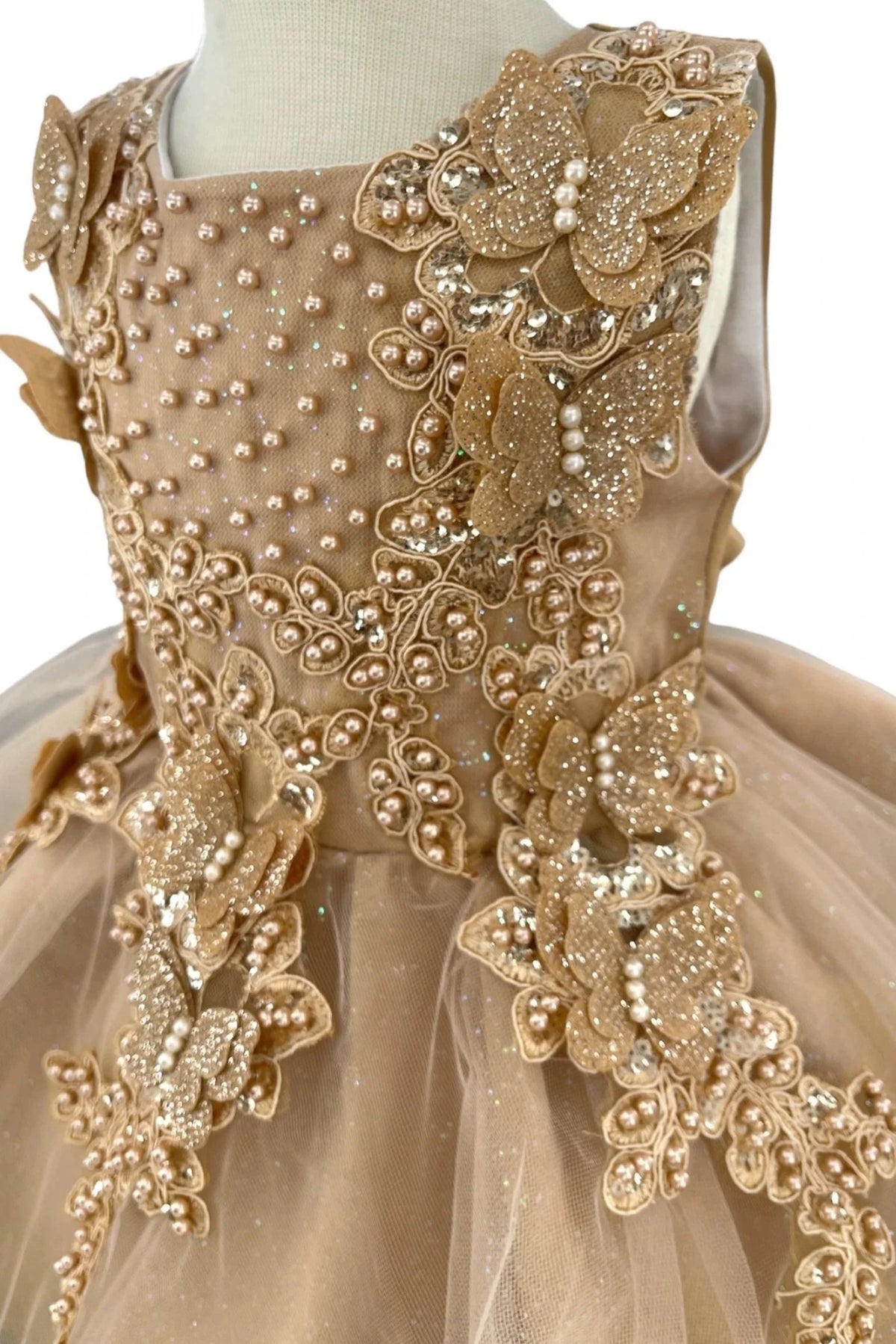 Embroidered flowers surround the pearl accents on this Gold flower girl baby dress bodice.