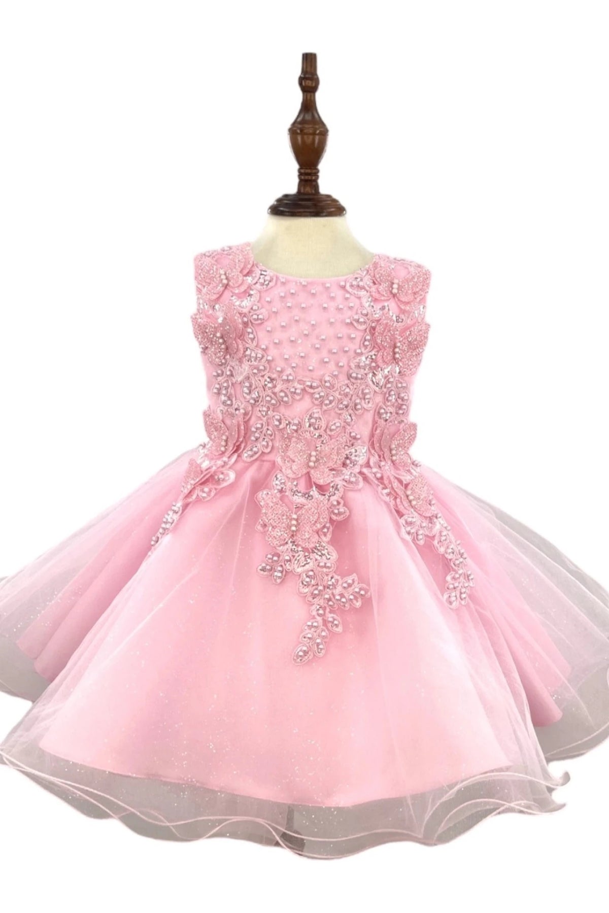Floral lace extends from the bodice onto the Pink flower girl baby dress tulle skirt.