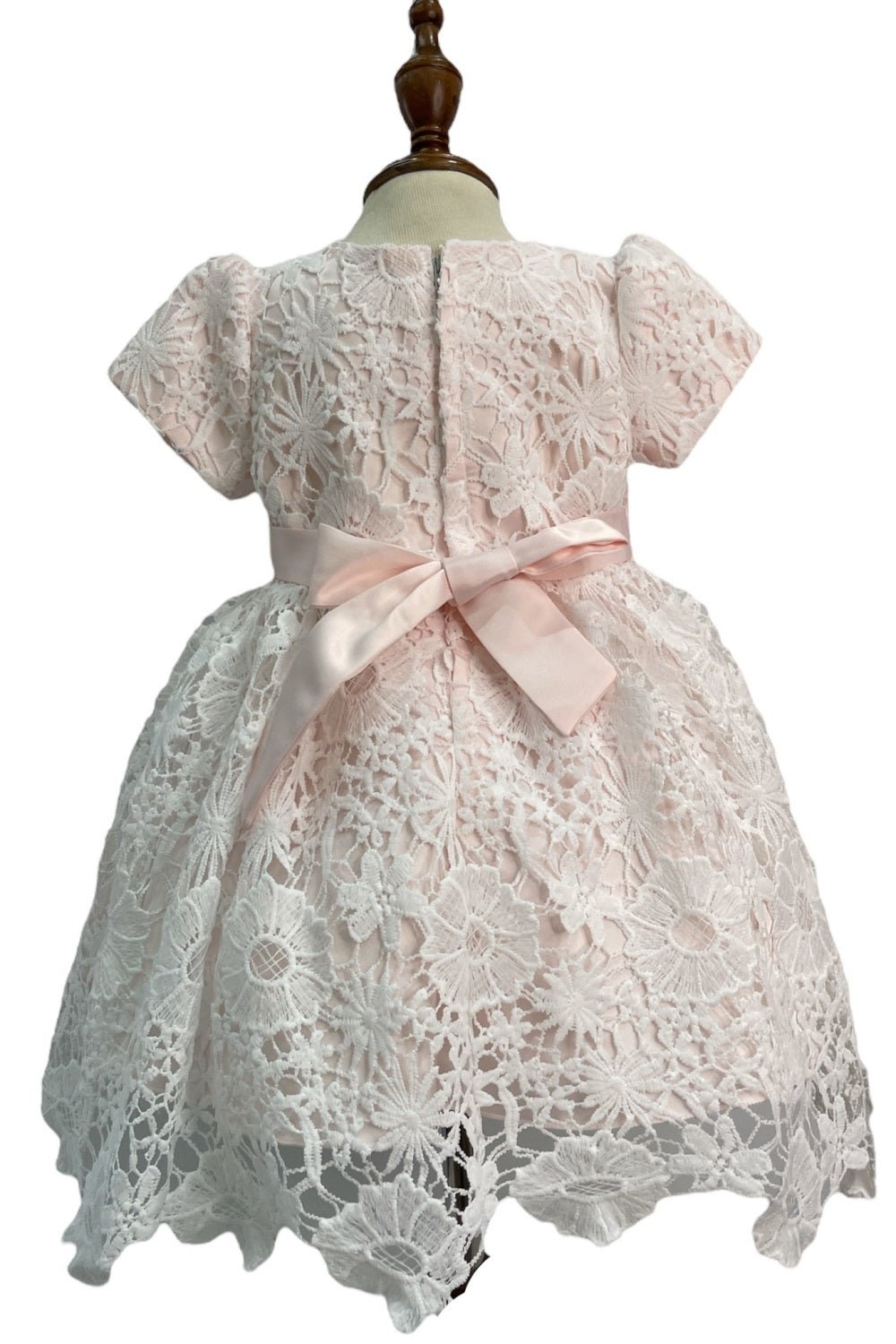 Pink flower girl dress back view highlighting full skirt and elegant silhouette.