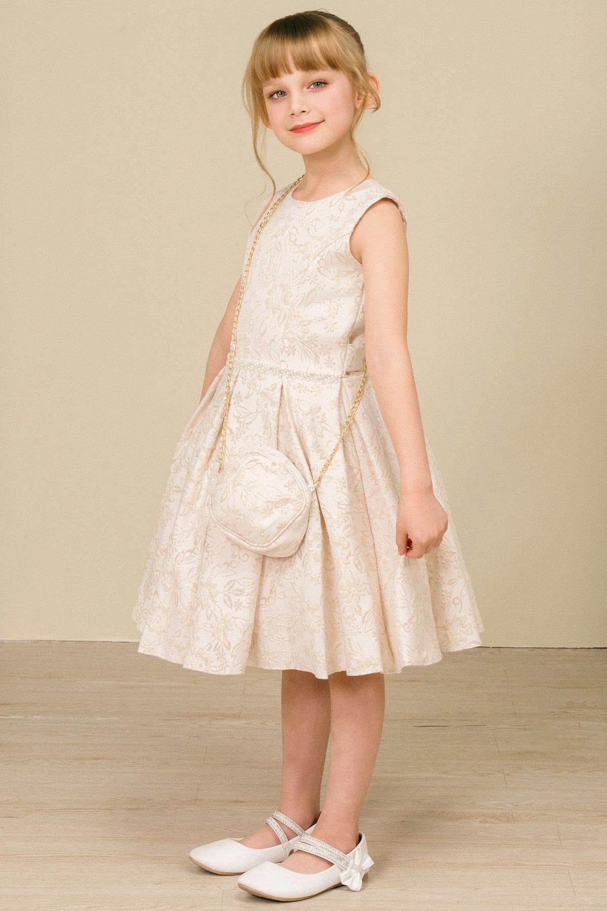 Featuring with floral jacquard texture, this Champagne kids party dress displays elegant detail.