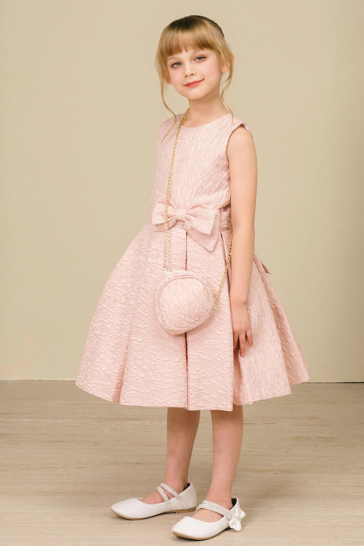 Featuring with a pleated jacquard skirt, this Pink kids party dress displays elegant detail.