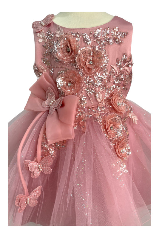 Close-up front view of dusty rose dress showing shimmering fabric and bow accent