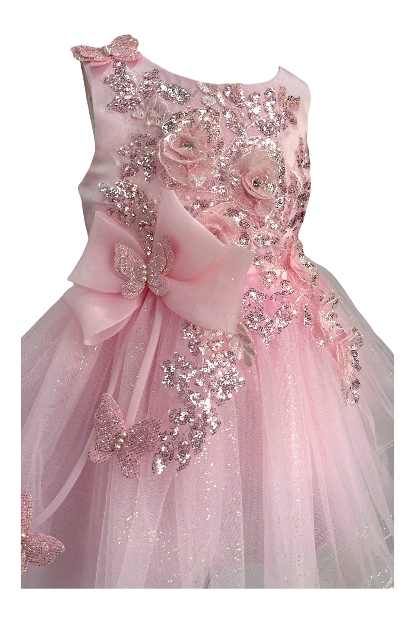 Close-up front view of pink dress showing shimmering fabric and bow accent