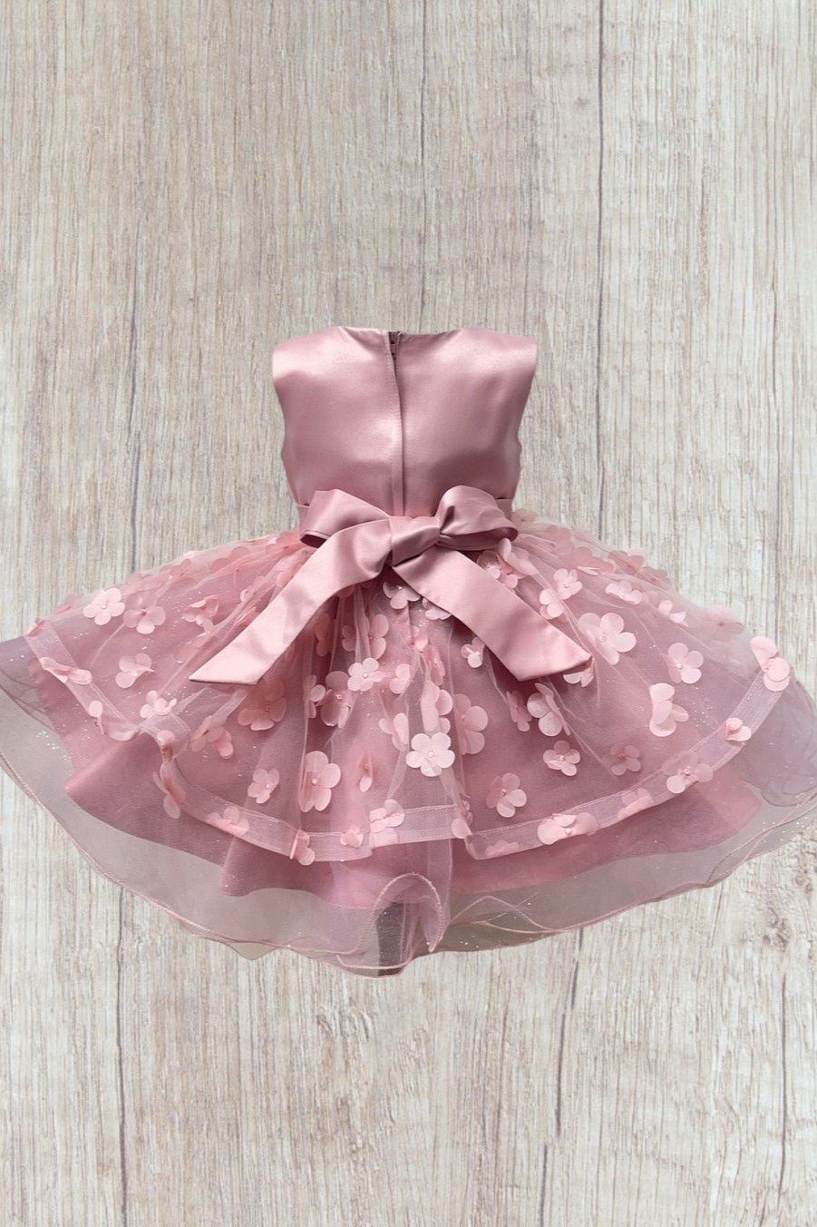 Dusty rose flower girl dress back view highlighting elegant fit and classic silhouette.