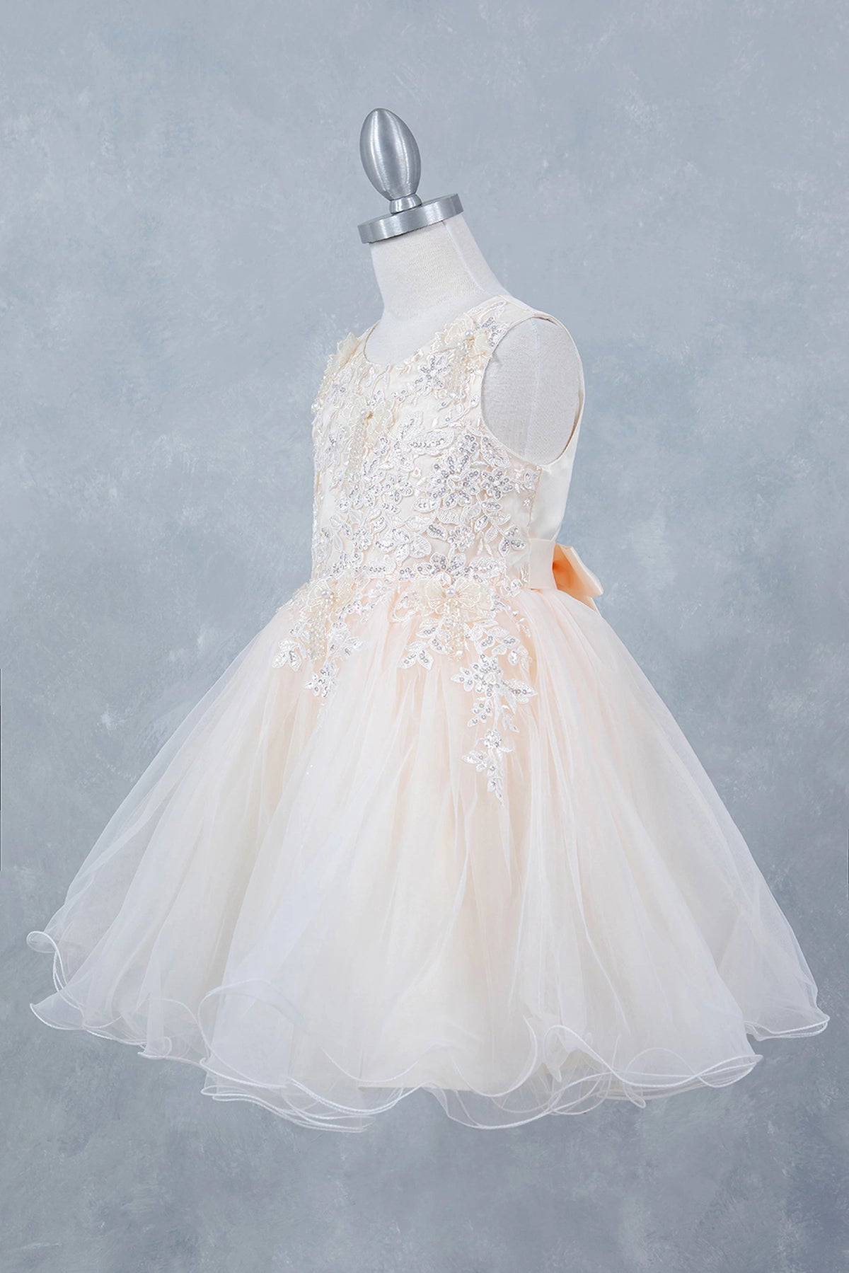 Featuring with a full tulle skirt, this Champagne kids party dress displays elegant detail.
