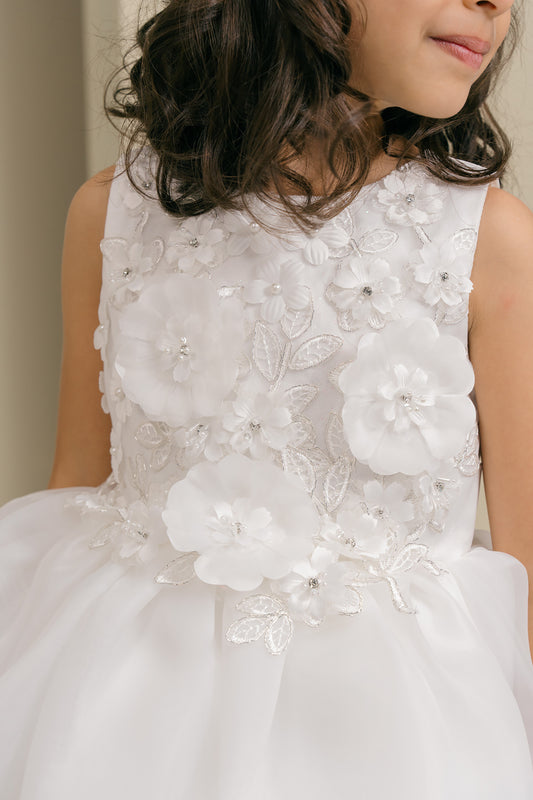 White floral dress with intricate details on a plain background