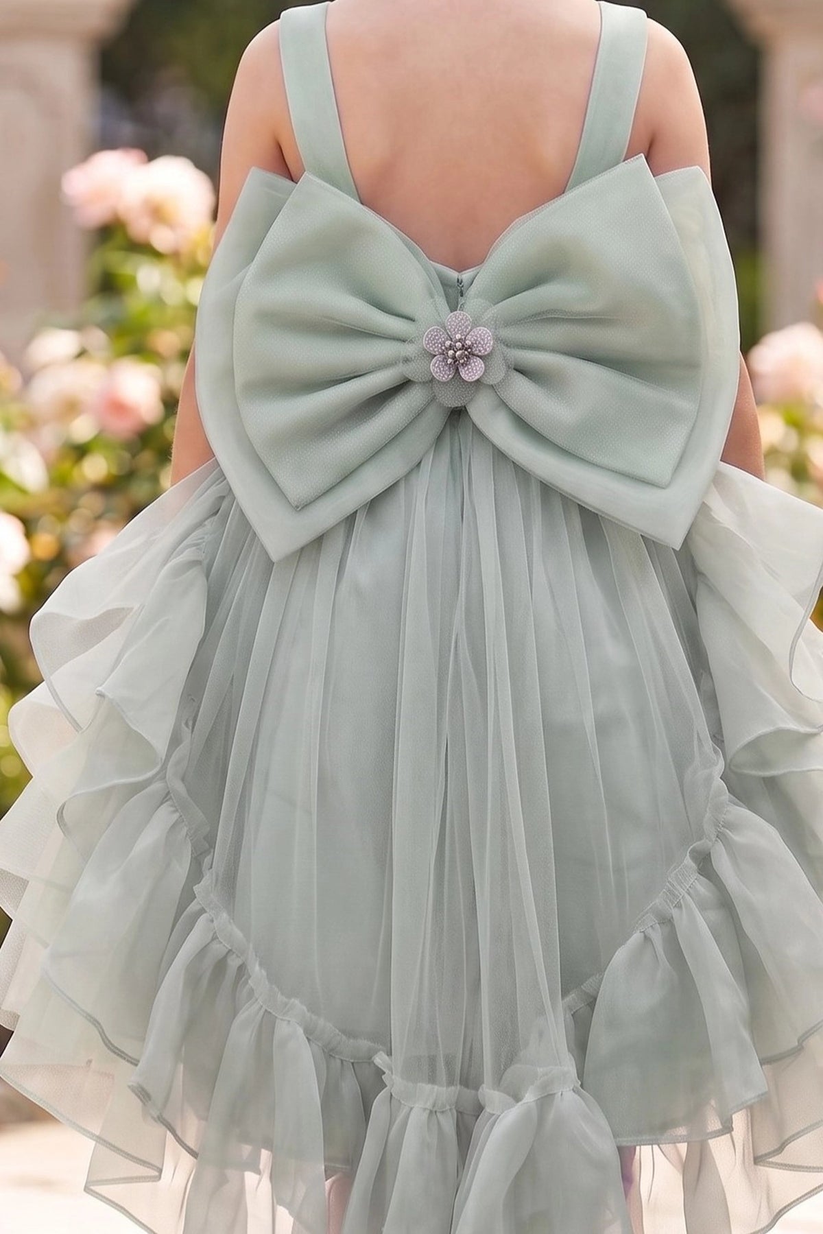 Featuring jeweled center on the large satin bow on the Sage flower girl dress.