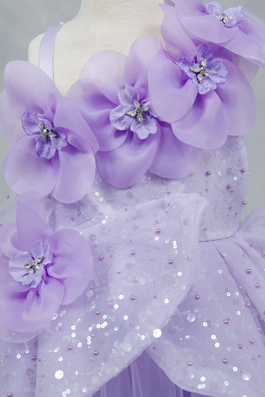 Close-up front view of lilac dress showing shimmering fabric and bow accent