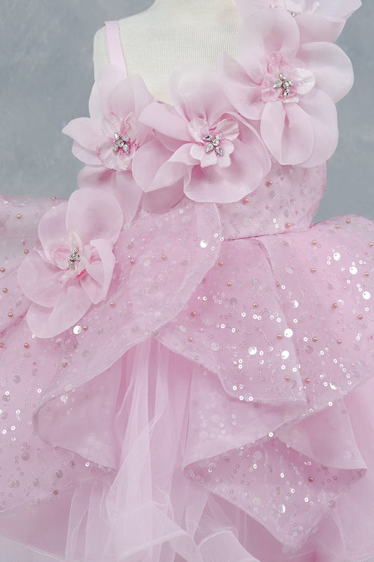 Close-up front view of pink dress showing crystal floral detail and sequin texture