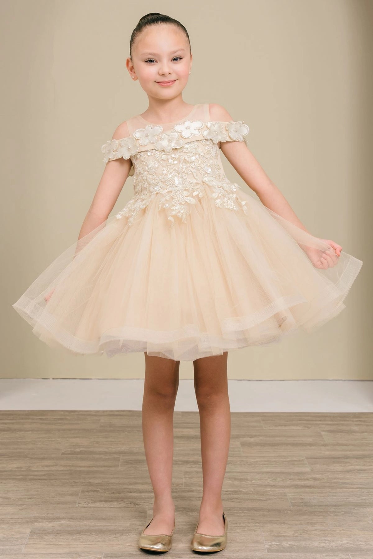 Champagne flower girl dress features floral shoulder trim and embroidered bodice.