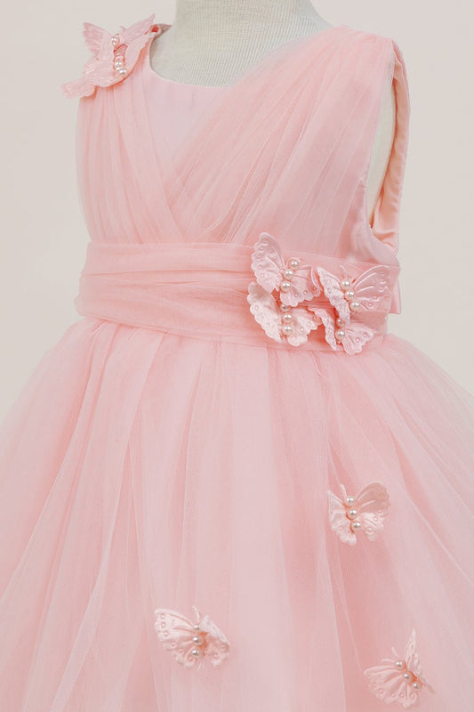Close-up front view of peach dress showing shimmering fabric and bow accent