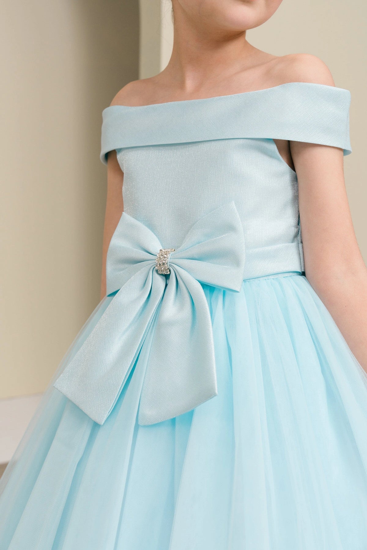 Visible on this Blue flower girl dress: jeweled front bow below the satin bodice.