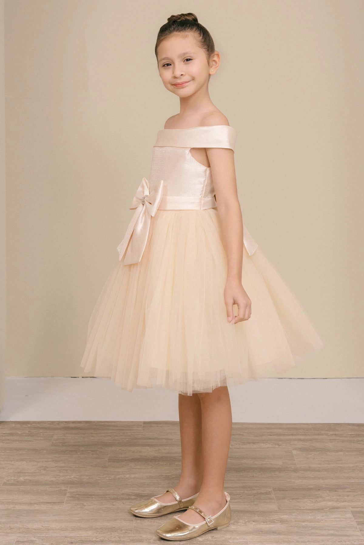 Featuring off-shoulder bodice and flared tulle hem on the Champagne flower girl dress.