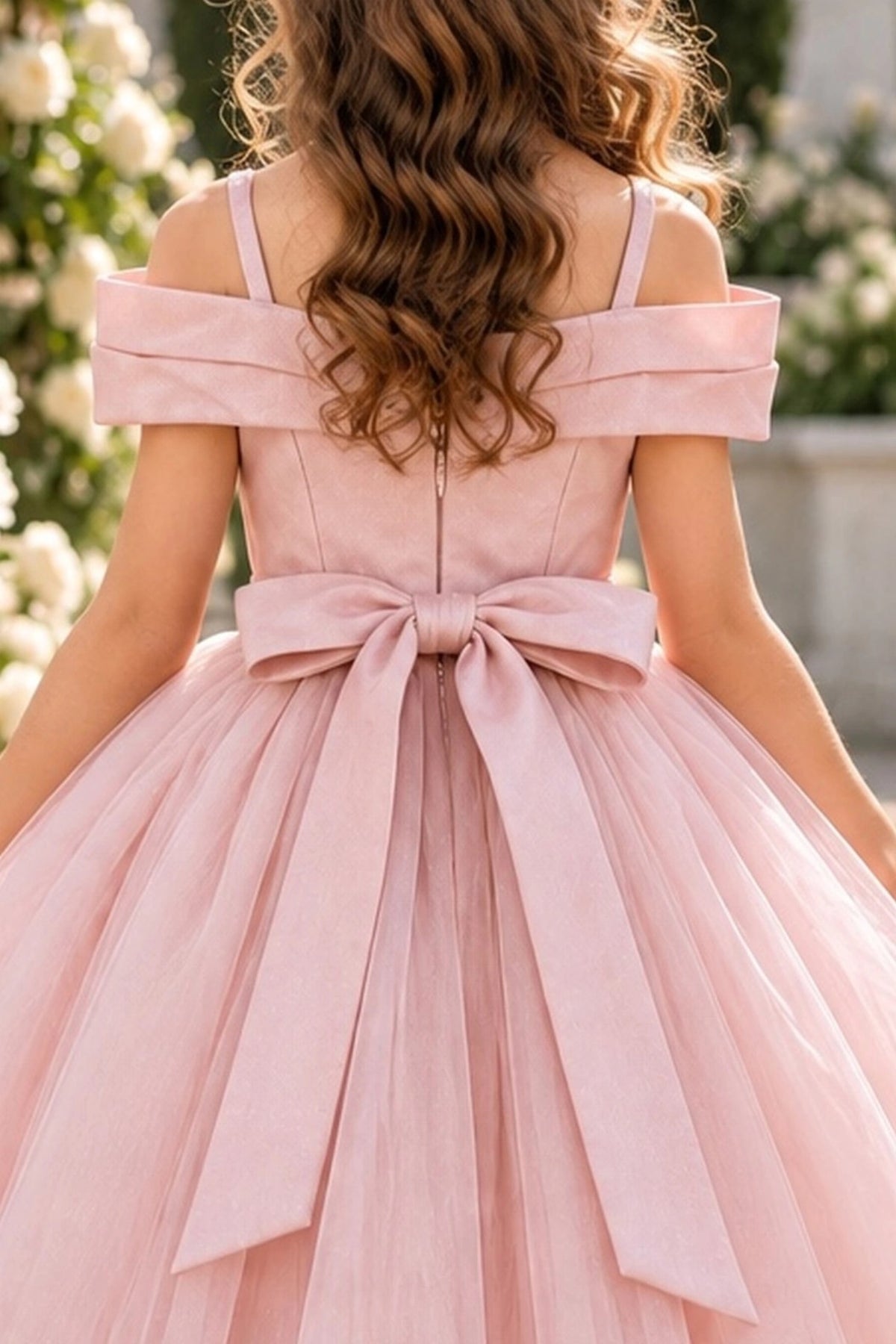 Finished with a back bow, this Blush kids dress shows its rear construction.