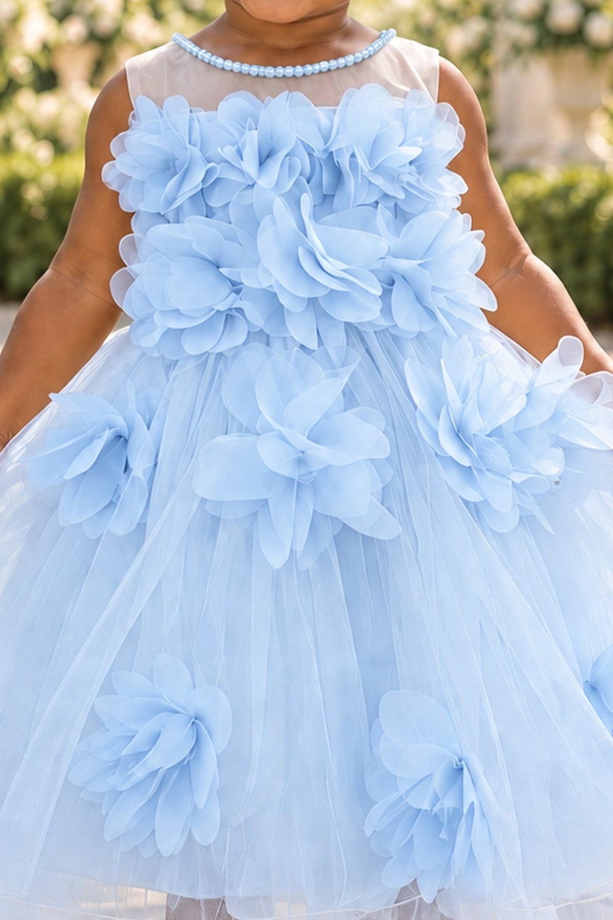 Detailed a sheer upper neckline complements the Blue kids dress.