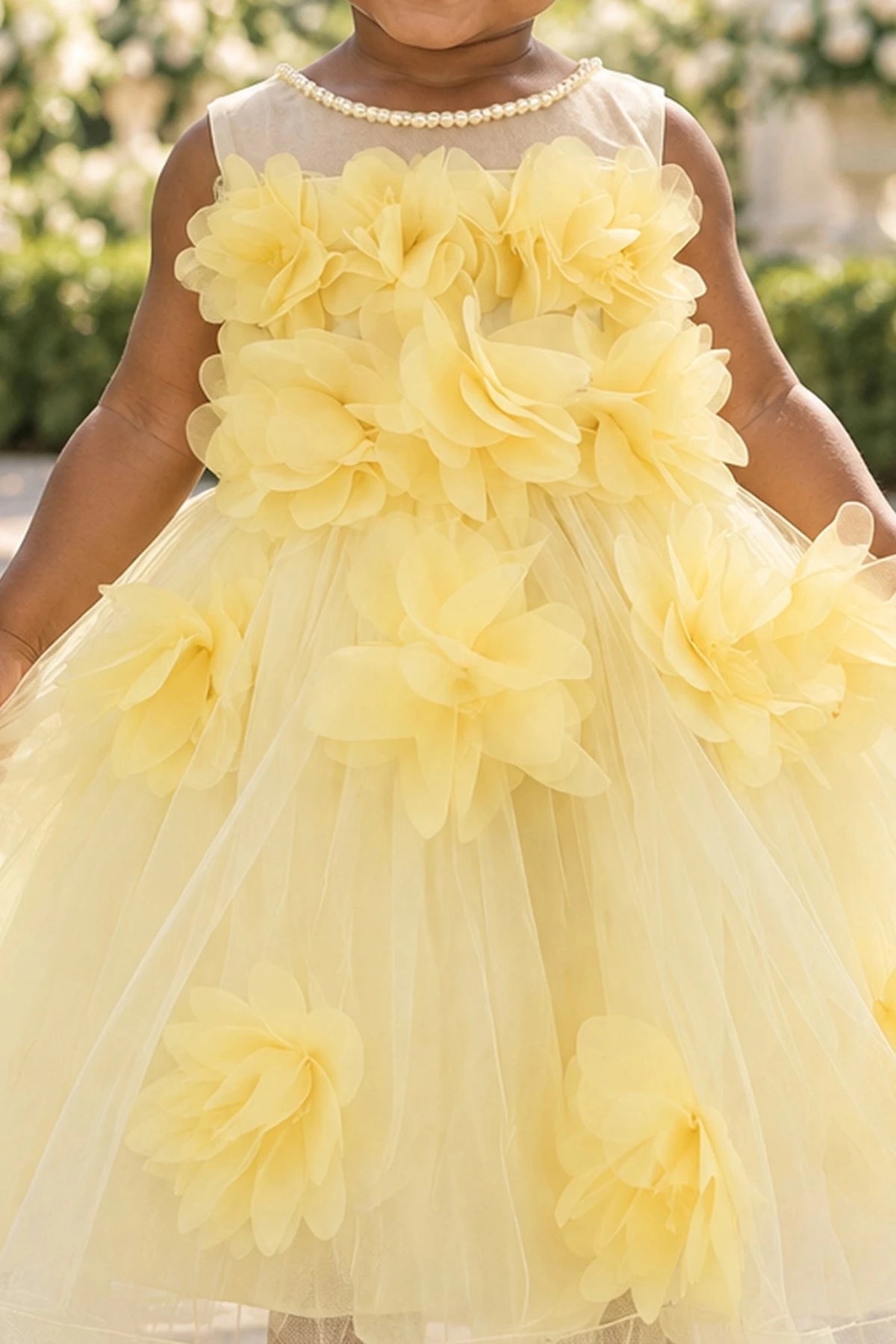 Detailed a sheer upper neckline complements the Yellow kids dress.