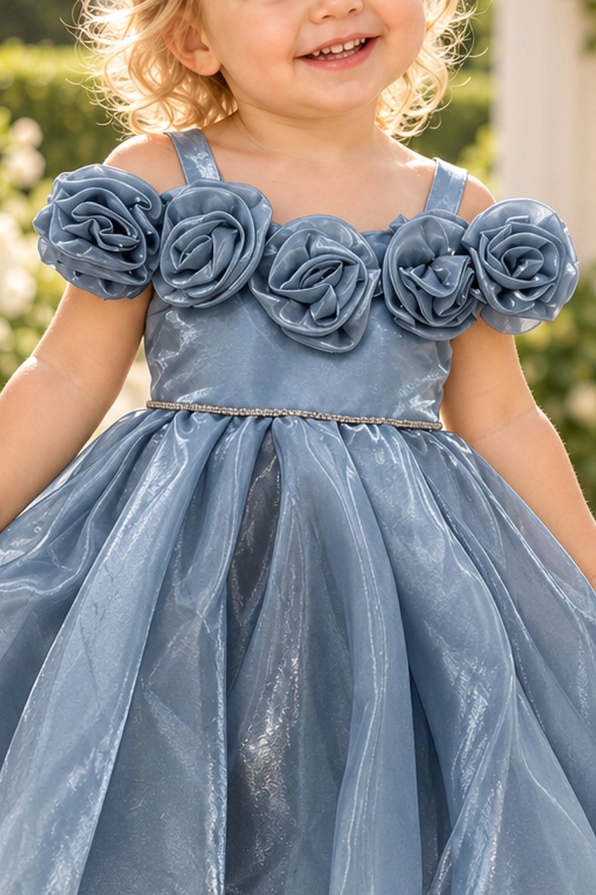 Layered shaping highlights rosettes framing the neckline on the Dusty Blue kids dress.