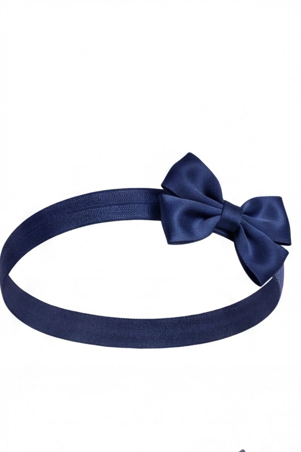 Matching bow headband accompanies the Navy kids dress with rosette details across the bodice.