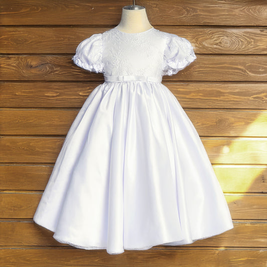 White dress on a mannequin against a wooden background