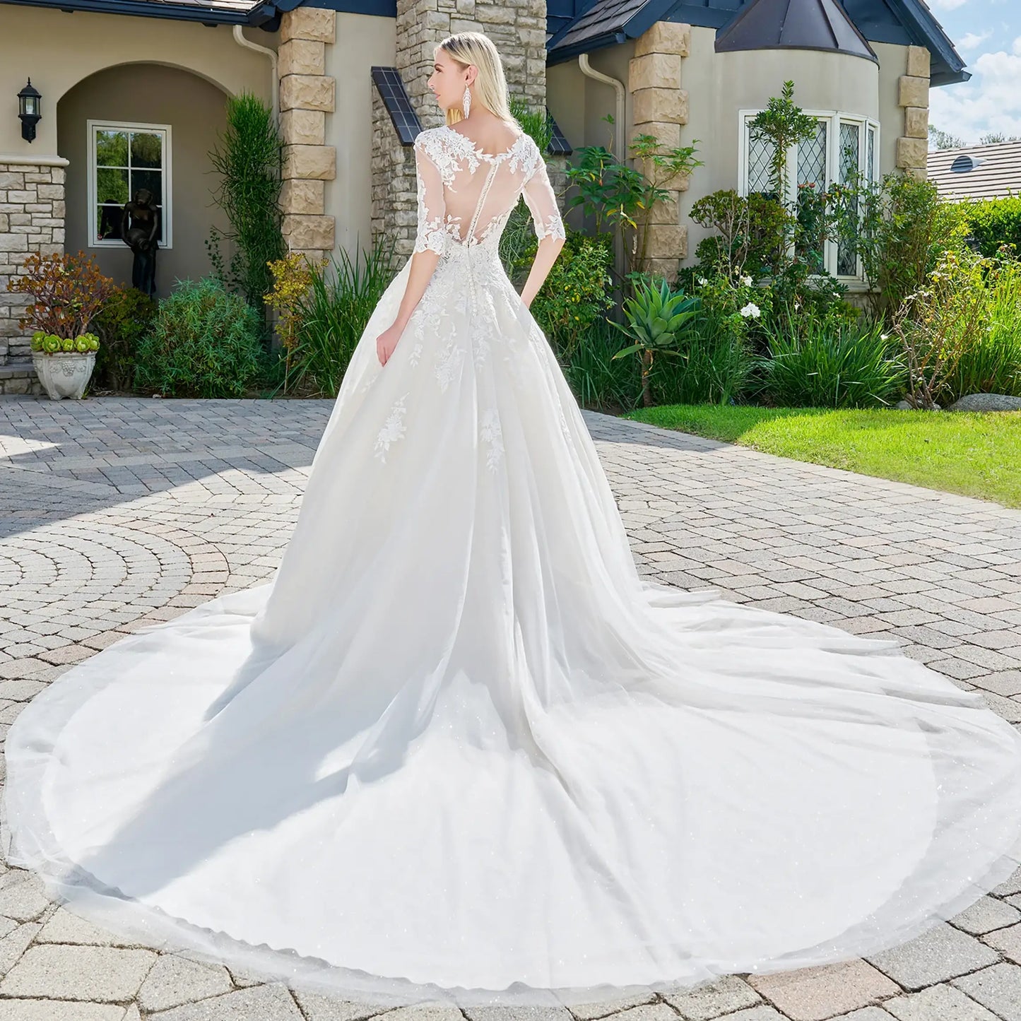 Front full-length view of Ivory/Cream ball gown wedding dress with embroidered glitter mesh, V-neckline, half sleeves with beads and jewels, and sheer button-closure back