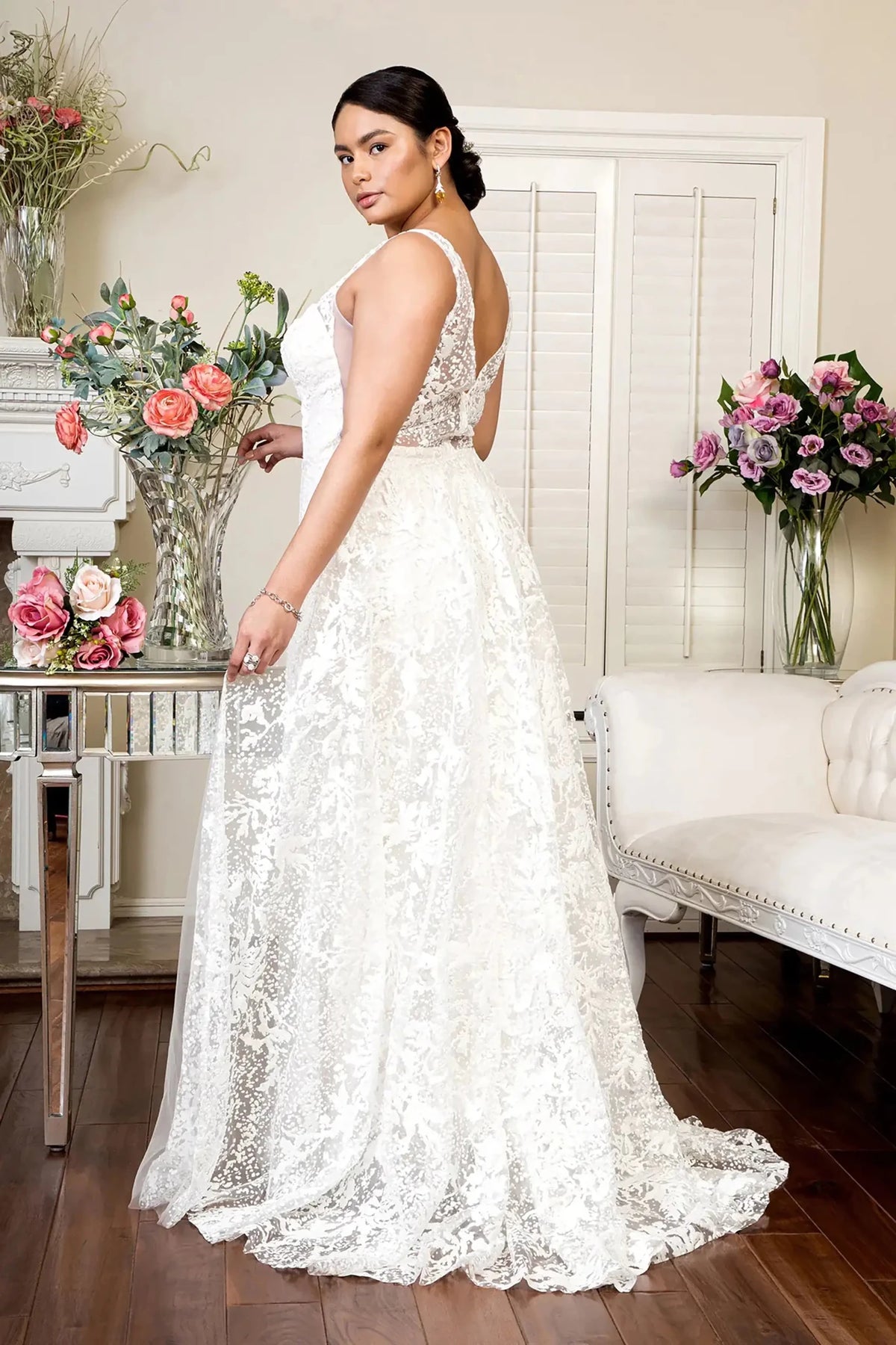 Rear view reveals ivory glitter mermaid wedding dress with illusion V-neckline, sheer V-back, straps and mesh overlay.