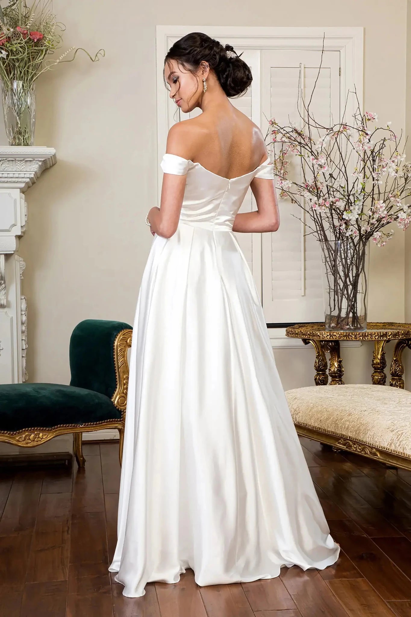 Back full-length view showcasing the elegant flow of the pleated A-line skirt and the trailing hemline of the bridal gown.