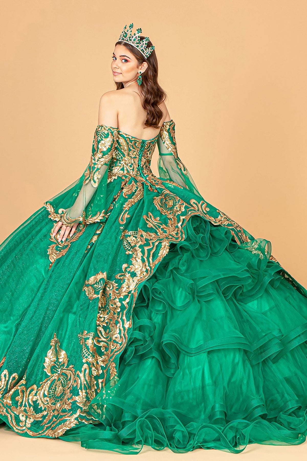 Full-length view highlights emerald green quinceañera dress with sequin embellishments, glitter mesh and detachable mesh sleeves.