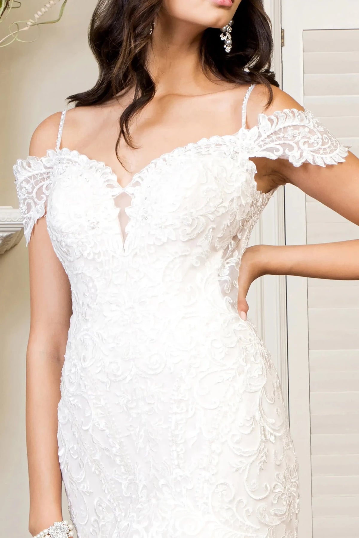 Close-up view reveals Ivory Cream wedding dress with the delicate spaghetti straps.