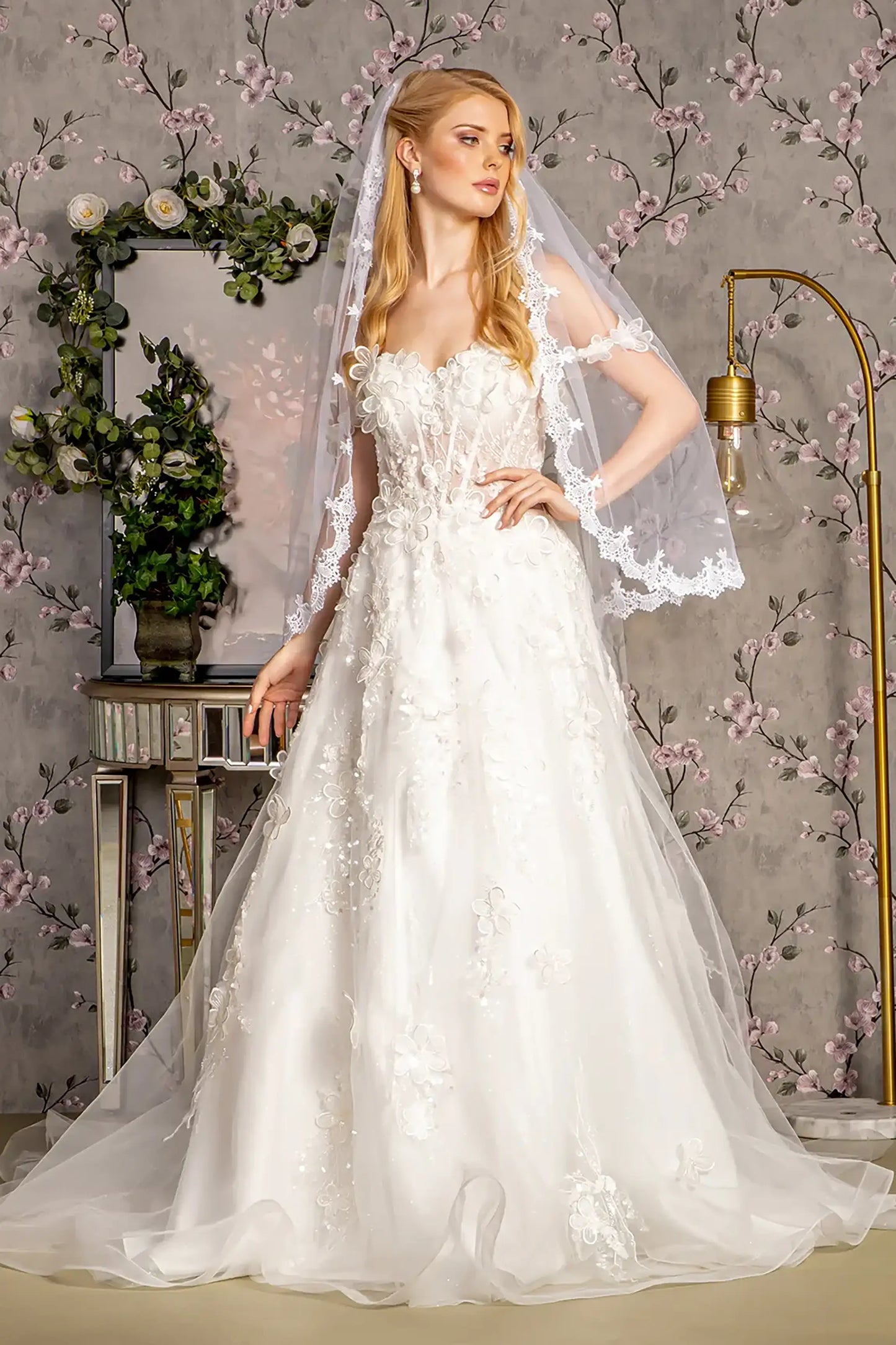 Front full-length view focusing on the delicate floral textures and the sheer construction of the back, complemented by a matching lace-edged veil.
