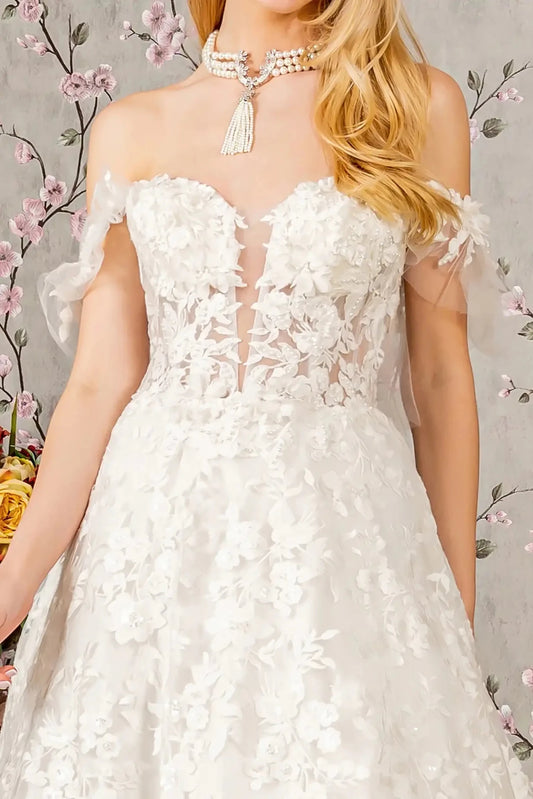 Front close-up upper view highlighting the shimmering gemstone and sequin embellishments woven into the floral appliqué and the delicate texture of the off-shoulder mesh sleeves.
