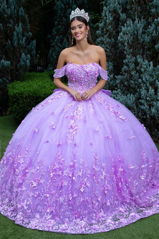 Woman in a lilac 3d flowers quince ball gown with off shoulder standing outdoors.