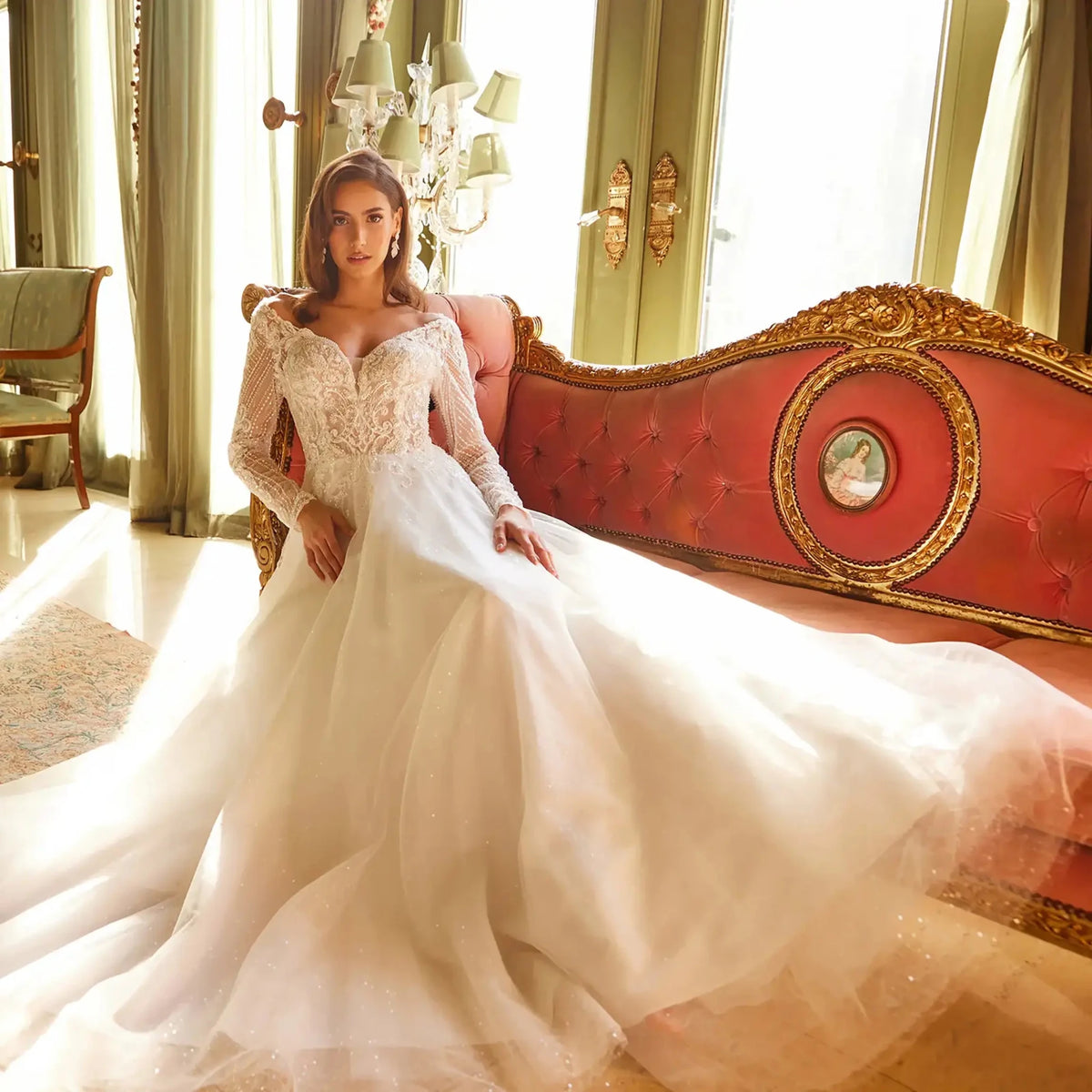 Detailed view highlights an off-white A-line wedding dress featuring an illusion off-the-shoulder neckline.