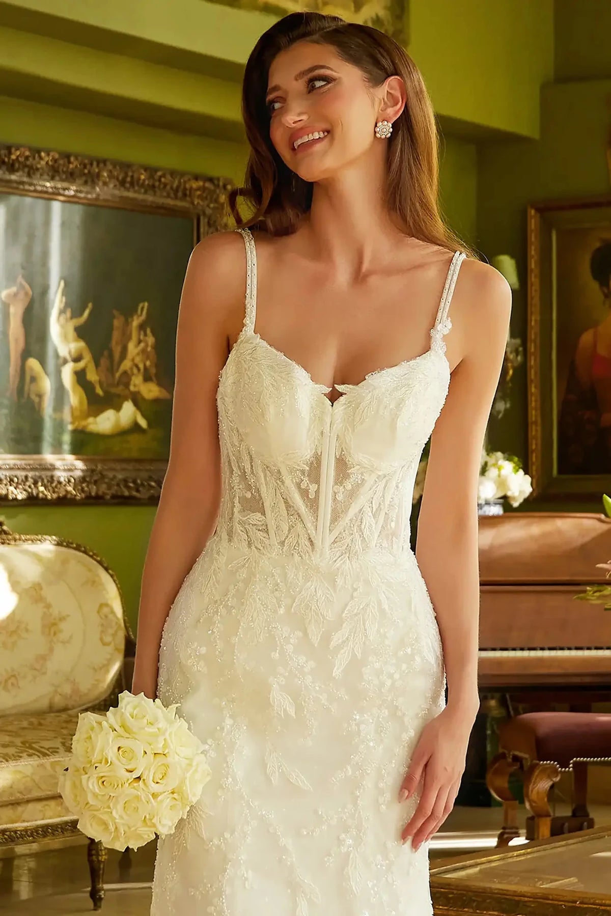 Close-up view reveals Off White wedding dress with the shimmering sequins and floral beadwork on the V-neck bodice.